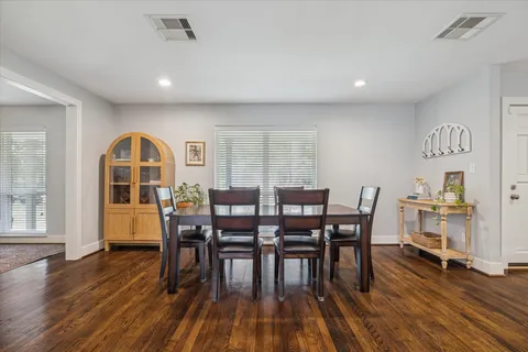 a view of a a dining room with furniture window and wooden floor