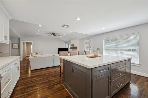 a kitchen with a stove and a wooden floor