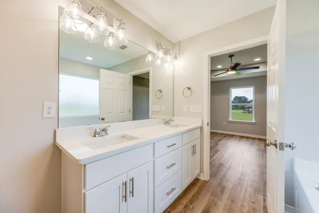 a spacious bathroom with a double vanity sink mirror and