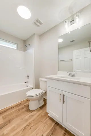a view of a room with wooden floor
