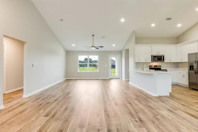 a view of kitchen with granite countertop cabinets and wooden floor
