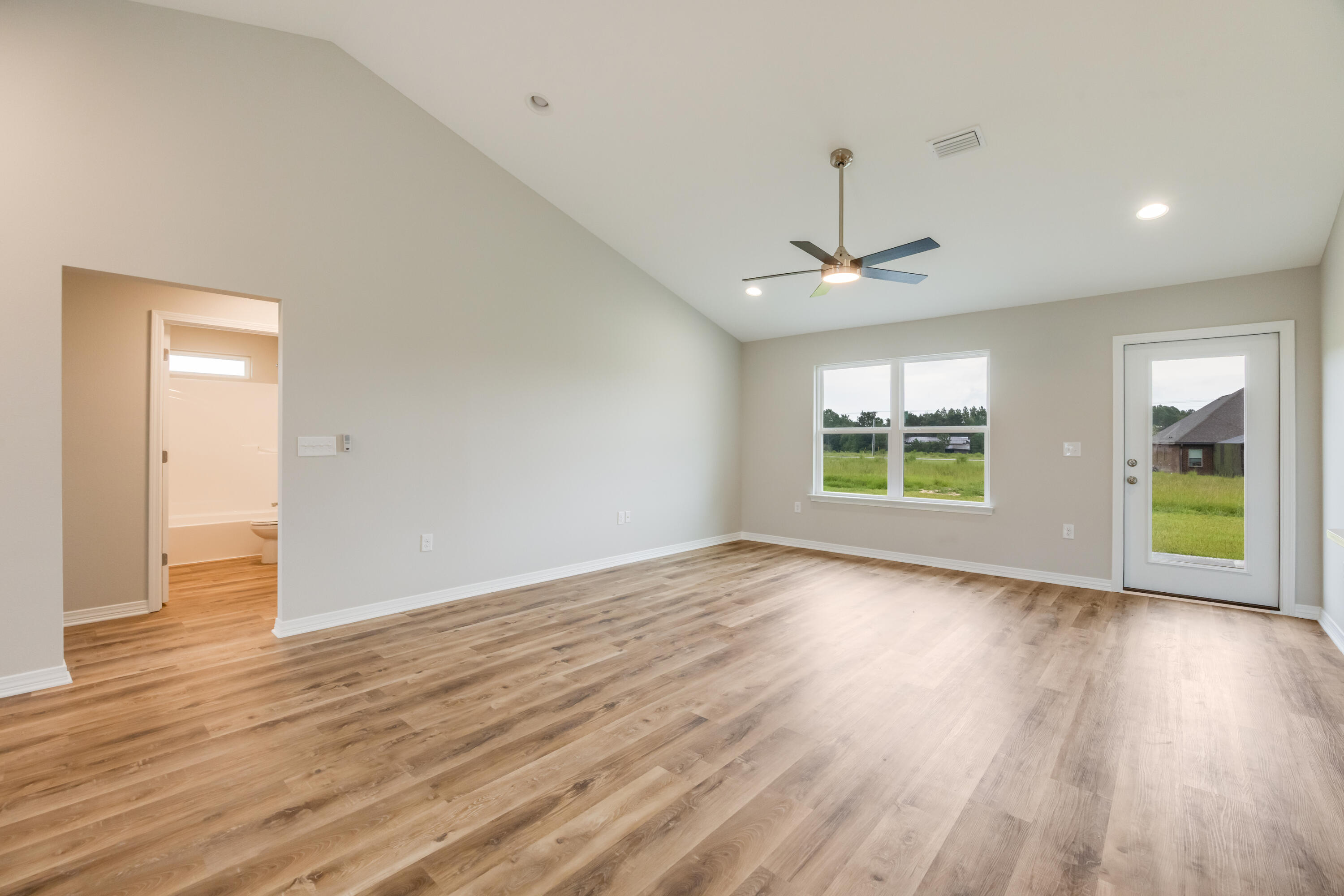 3203 Liz Court Crestview, FL 32539 - Photo 6 of 35 a view of an empty room with wooden floor and a window