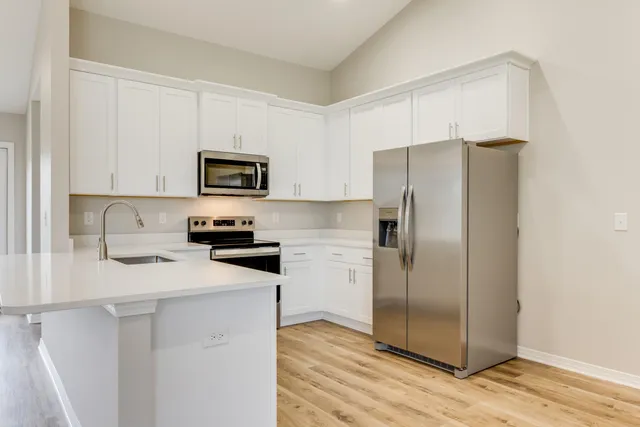 a kitchen with a refrigerator sink and microwave