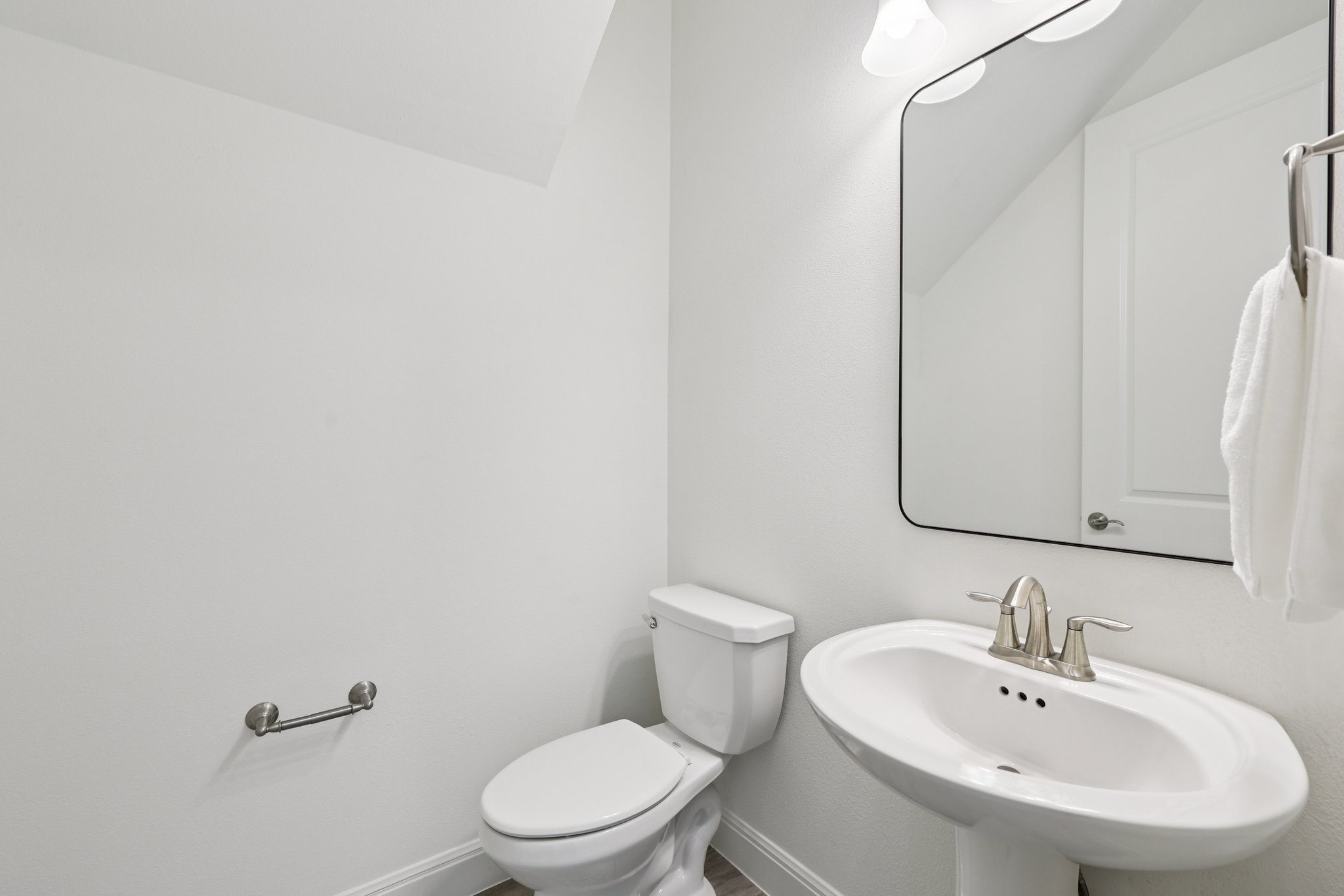 12500 Simmental Drive Austin, TX 78732 - Photo 9 of 31 a white toilet sitting next to a bathroom sink