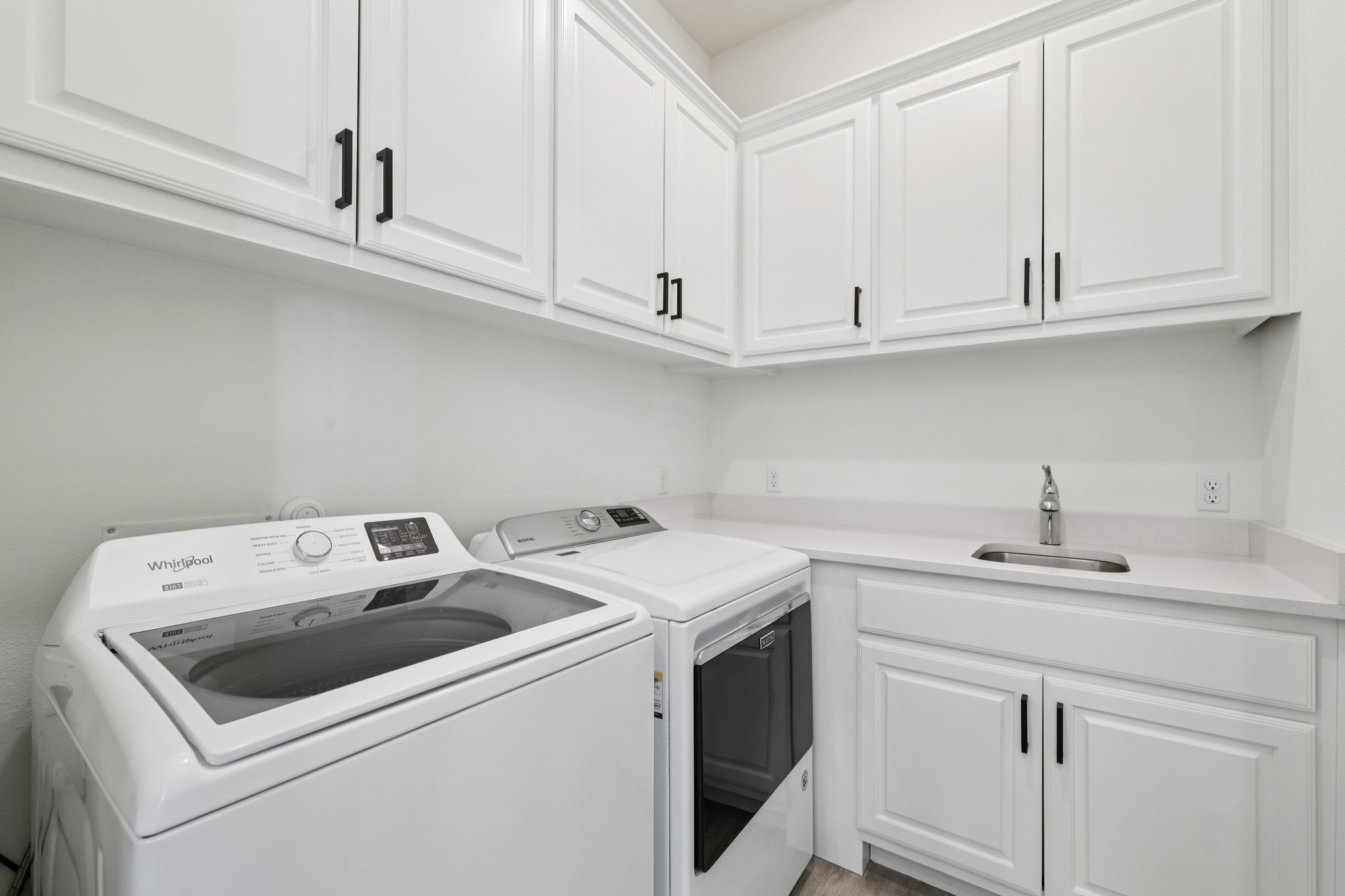 12500 Simmental Drive Austin, TX 78732 - Photo 10 of 31 a utility room with sink dryer and washer