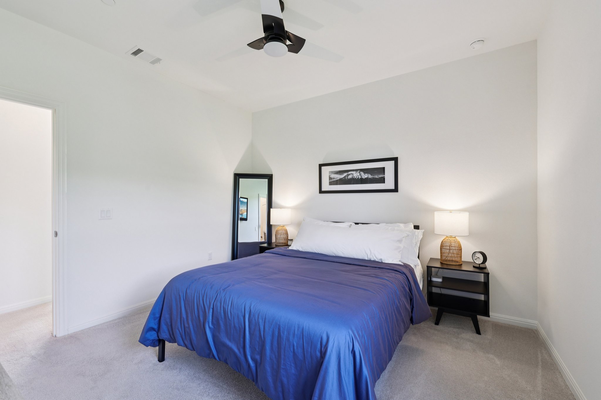 12500 Simmental Drive Austin, TX 78732 - Photo 11 of 31 a bedroom with a bed and a night stand