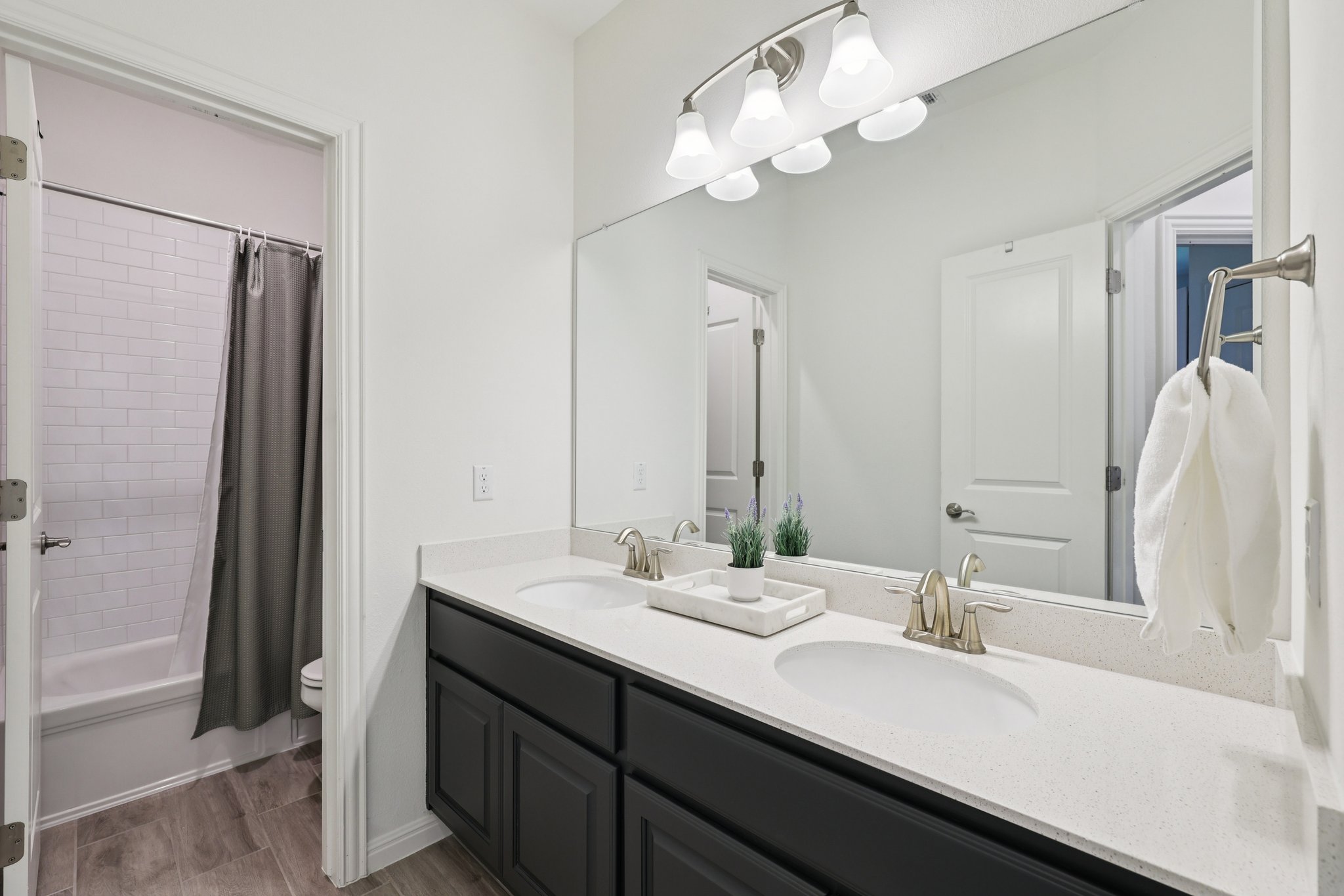 12500 Simmental Drive Austin, TX 78732 - Photo 14 of 31 a bathroom with a double vanity sink and a mirror