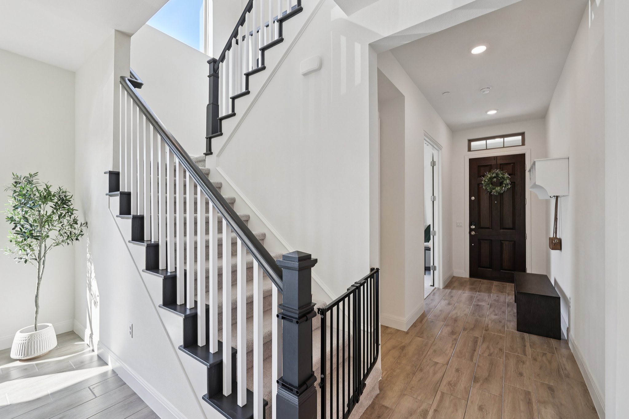 12500 Simmental Drive Austin, TX 78732 - Photo 5 of 31 a view of a hallway with wooden floor and stairs