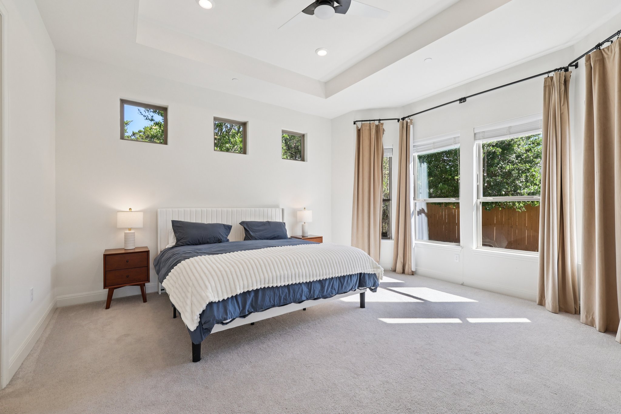 12500 Simmental Drive Austin, TX 78732 - Photo 6 of 31 a spacious bedroom with a bed painting and a large window