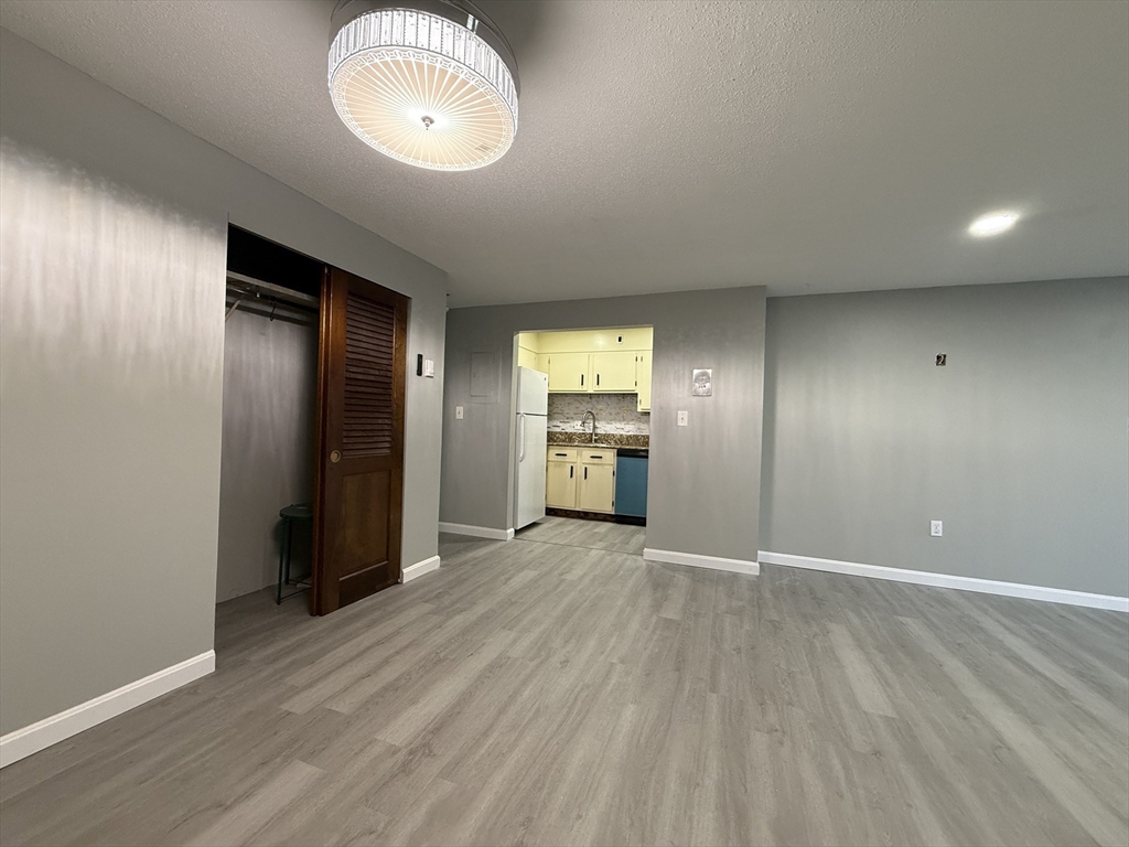1186 Worcester Road, Unit 610 Framingham, MA 01702 - Photo 14 of 37 wooden floor in an empty room with a window