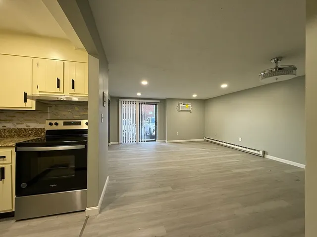 a view of an empty room with a fireplace