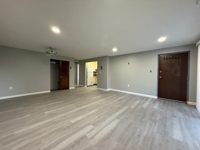 an empty room with closet and windows