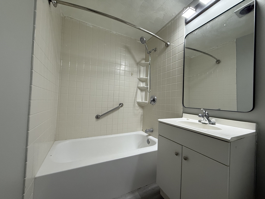 1186 Worcester Road, Unit 610 Framingham, MA 01702 - Photo 22 of 37 a bathroom with a sink and a mirror