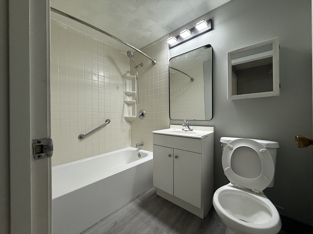 1186 Worcester Road, Unit 610 Framingham, MA 01702 - Photo 25 of 37 a bathroom with a toilet sink vanity granite shower and bathtub