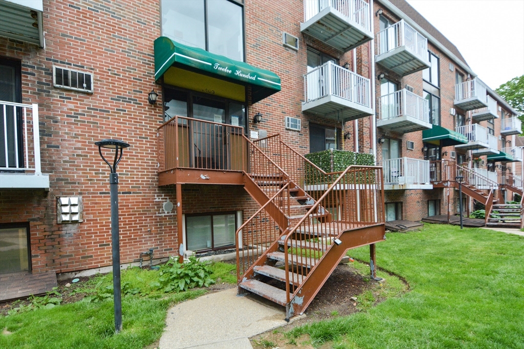 1186 Worcester Road, Unit 610 Framingham, MA 01702 - Photo 32 of 37 a front view of a house with a yard