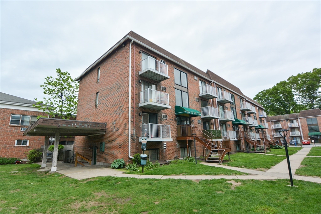 1186 Worcester Road, Unit 610 Framingham, MA 01702 - Photo 35 of 37 a front view of a house with a yard