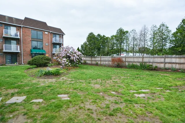a view of a house with a yard and sitting area