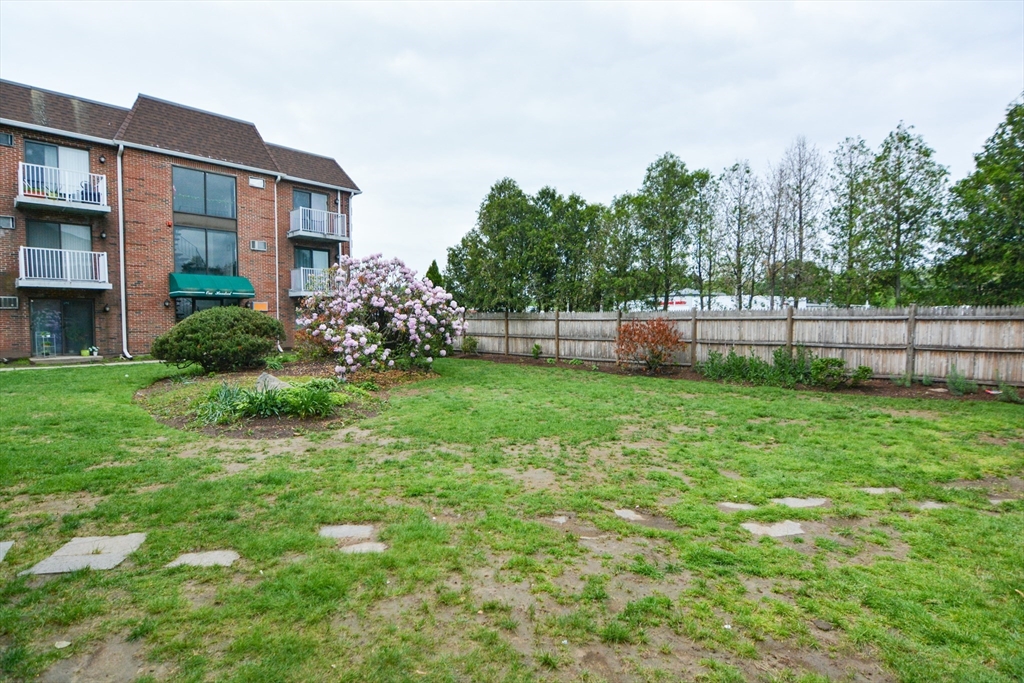 1186 Worcester Road, Unit 610 Framingham, MA 01702 - Photo 36 of 37 a view of a house with a yard and sitting area