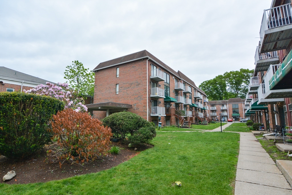 1186 Worcester Road, Unit 610 Framingham, MA 01702 - Photo 37 of 37 a view of a house with a yard and plants