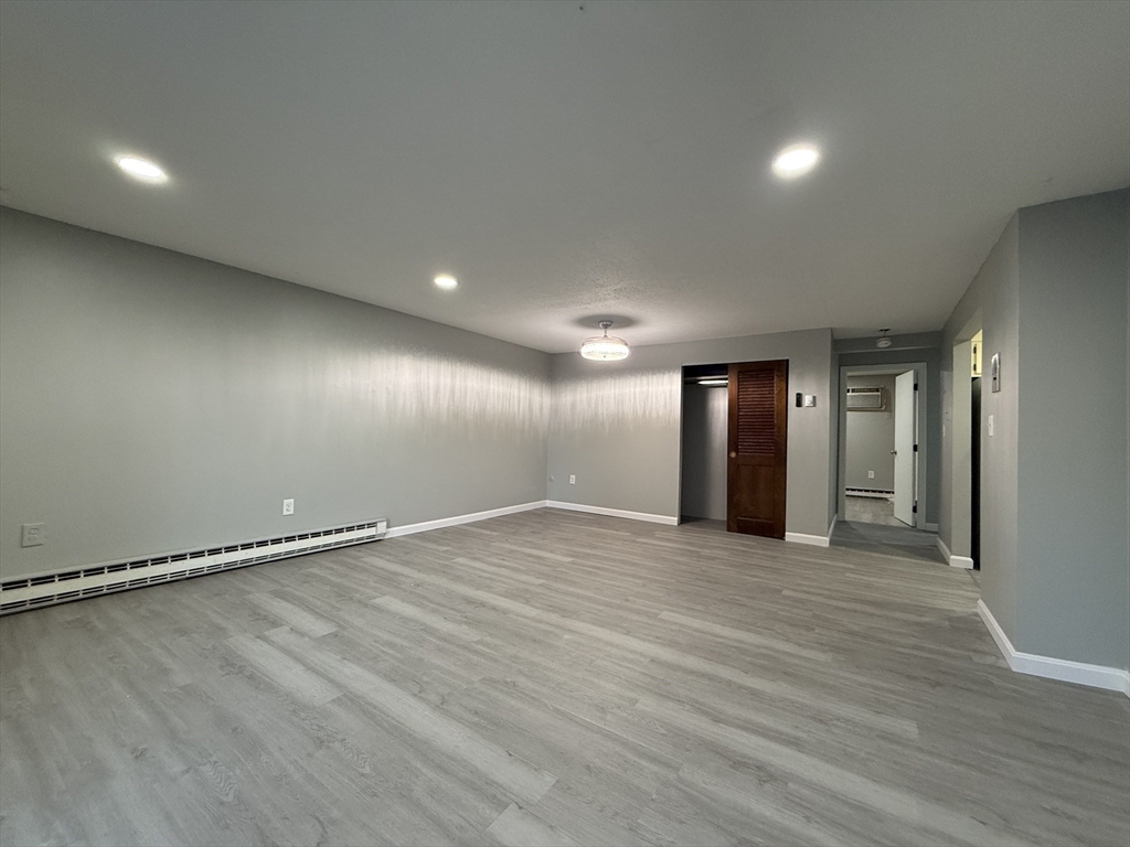 1186 Worcester Road, Unit 610 Framingham, MA 01702 - Photo 8 of 37 a view of an empty room with wooden floor
