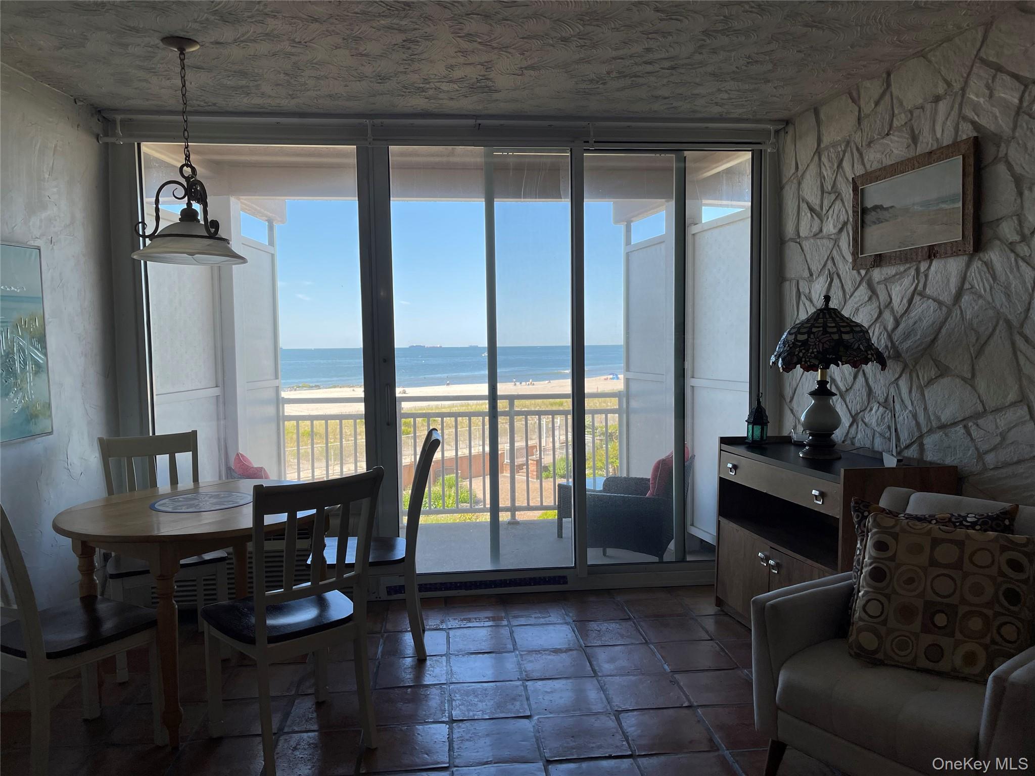 830 Shore Road, Unit 3E Long Beach, NY 11561 - Photo 11 of 13 a living room with furniture and a floor to ceiling window