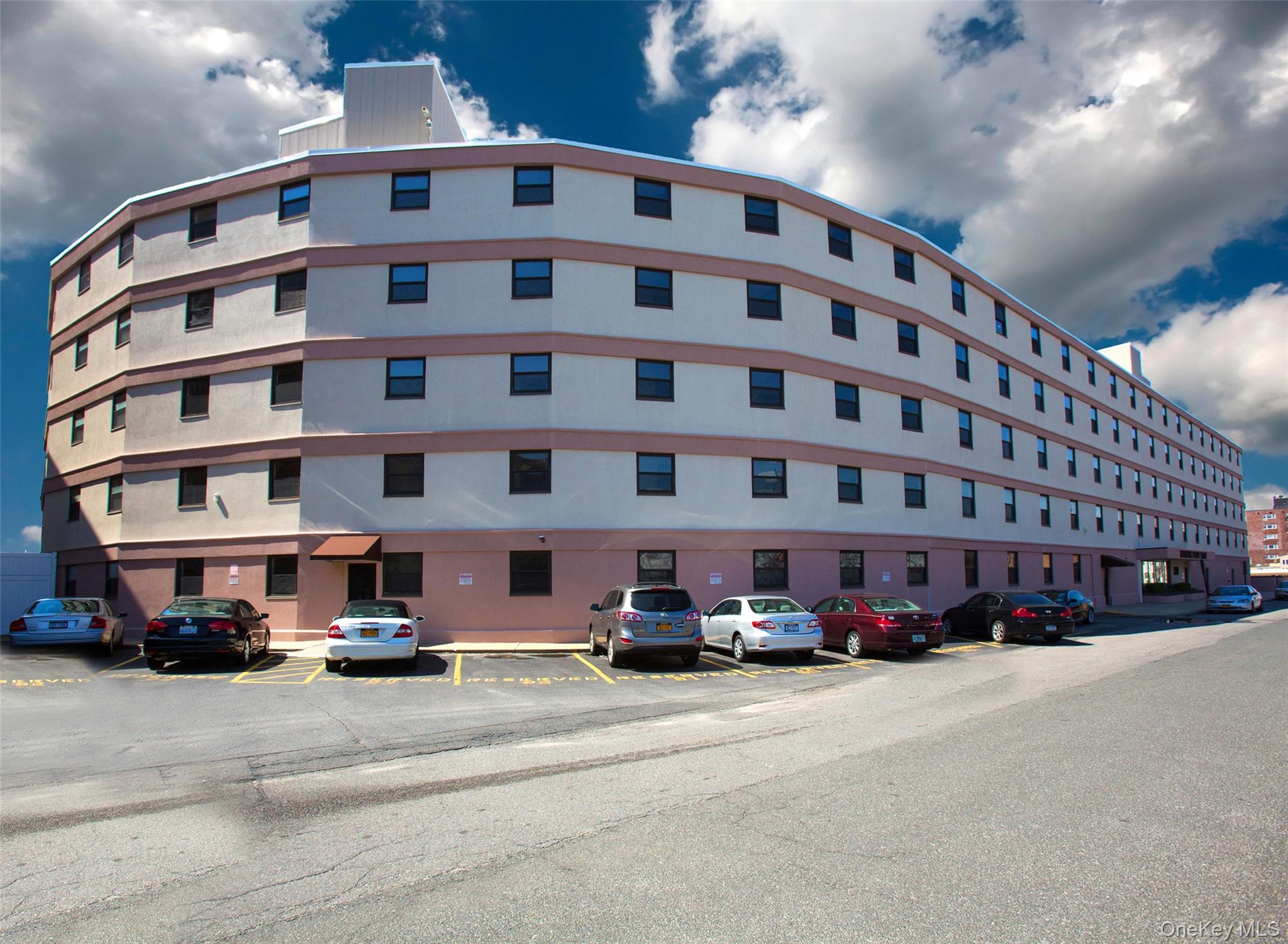 830 Shore Road, Unit 3E Long Beach, NY 11561 - Photo 2 of 13 a view of building with cars parked