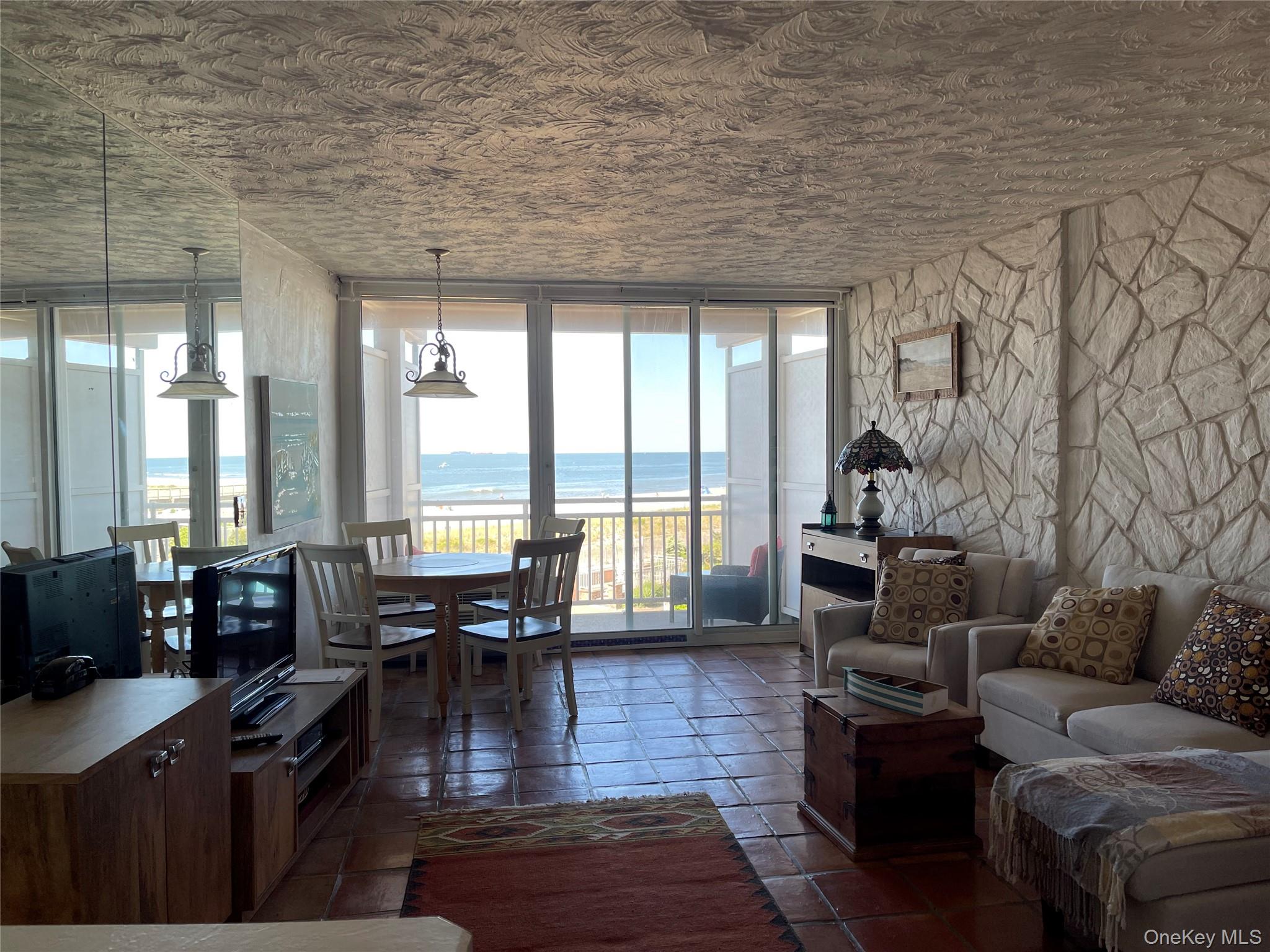 830 Shore Road, Unit 3E Long Beach, NY 11561 - Photo 4 of 13 a living room with furniture large wooden floor and floor to ceiling window