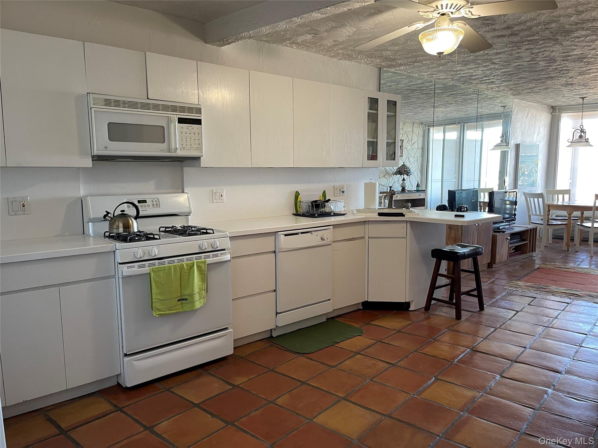 830 Shore Road, Unit 3E Long Beach, NY 11561 - Photo 5 of 13 a kitchen with a sink a stove and cabinets