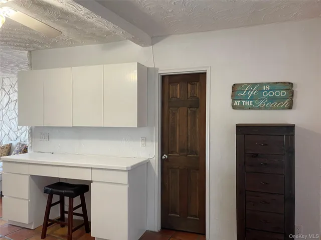 a kitchen with a sink cabinets and a refrigerator
