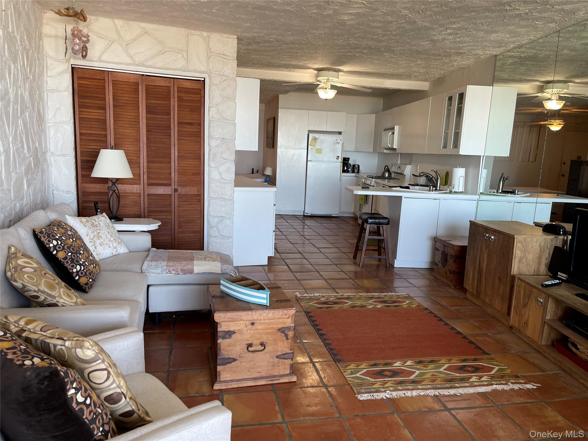 830 Shore Road, Unit 3E Long Beach, NY 11561 - Photo 7 of 13 a living room with furniture and a large window