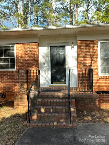 a porch with chairs and door