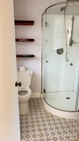 a bathroom with a toilet and a shower