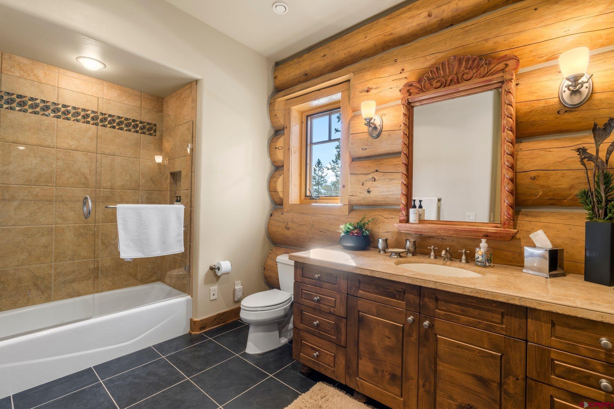 464 Pinnacle View Drive Durango, CO 81301 - Photo 21 of 35 a bathroom with a double vanity sink a large mirror and a bathtub