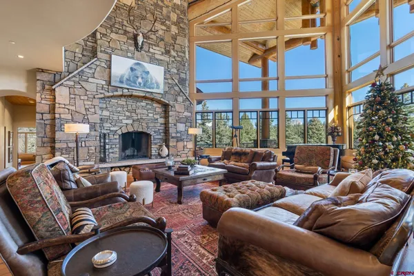a living room with furniture a rug and a large window