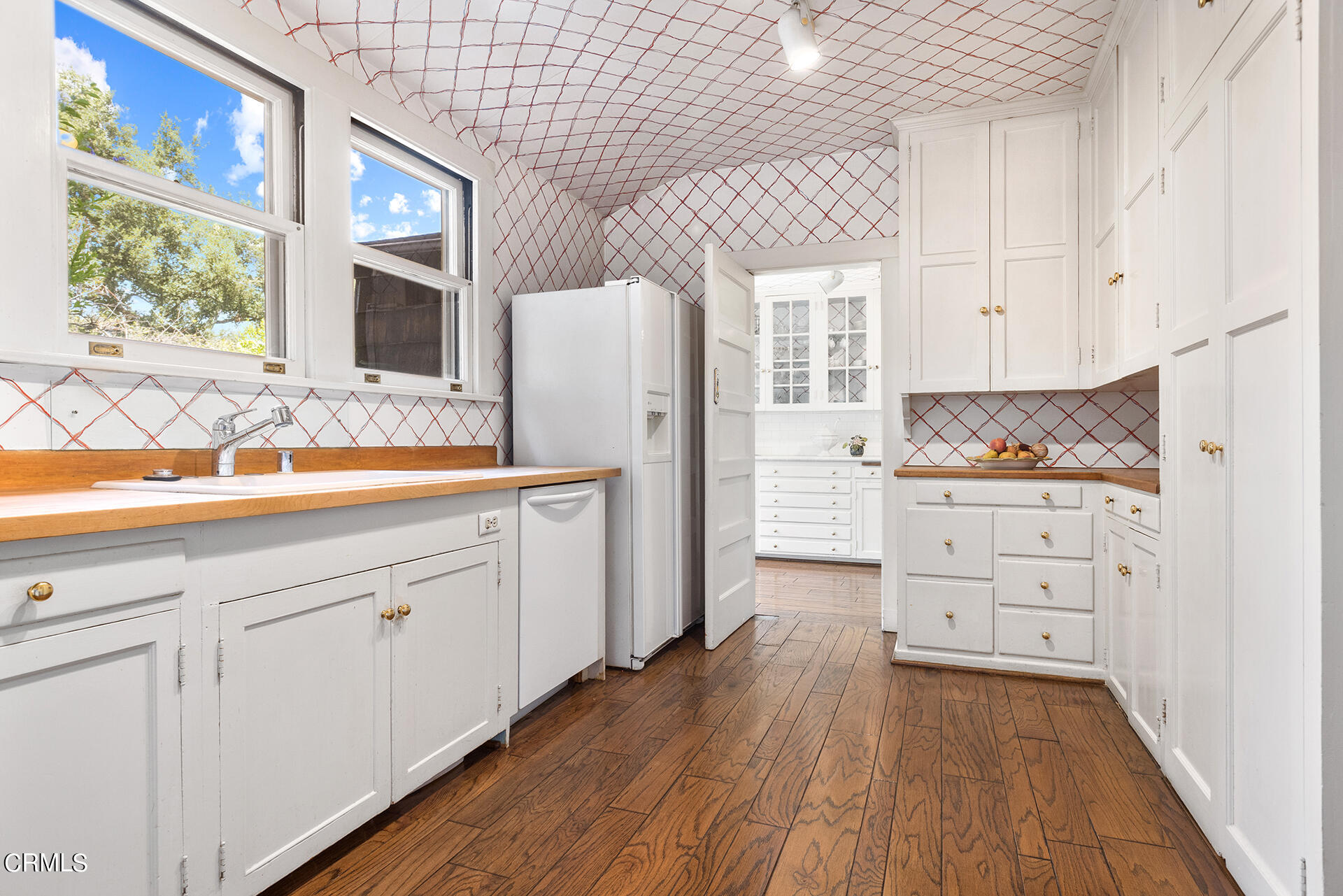 744 Rockwood Road Pasadena, CA 91105 - Photo 21 of 43 a kitchen with granite countertop white cabinets and white appliances