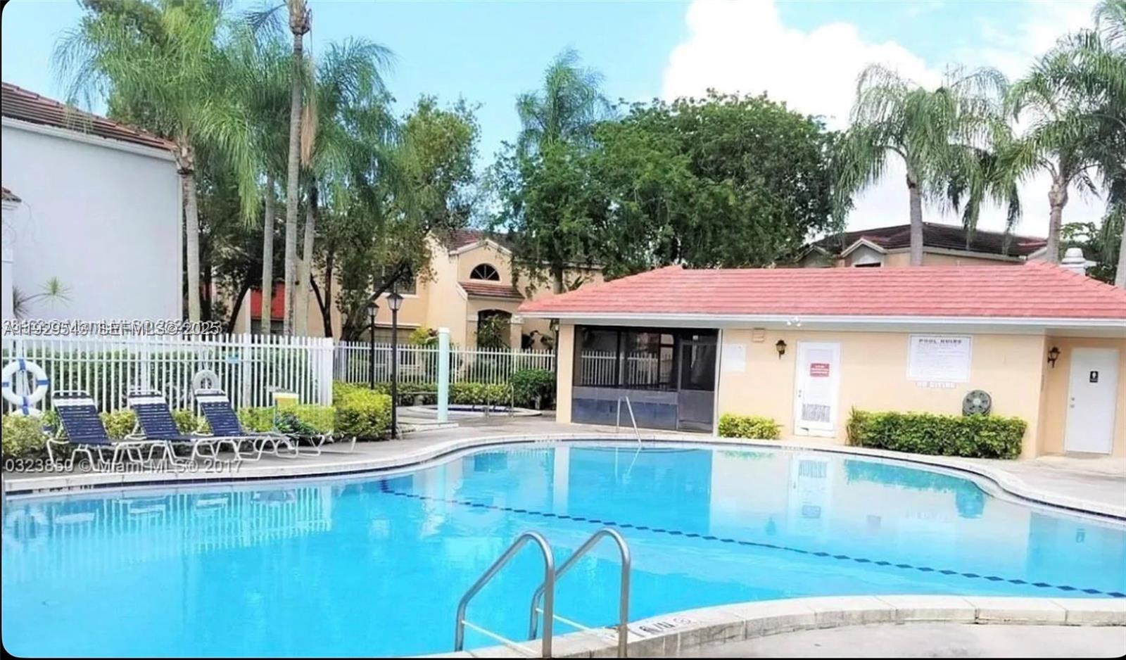 11864 Northwest 11th Street, Unit 11864 Pembroke Pines, FL 33026 - Photo 13 of 13 a view of a house with pool and sitting area