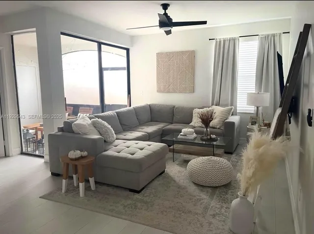 a living room with furniture and a large window