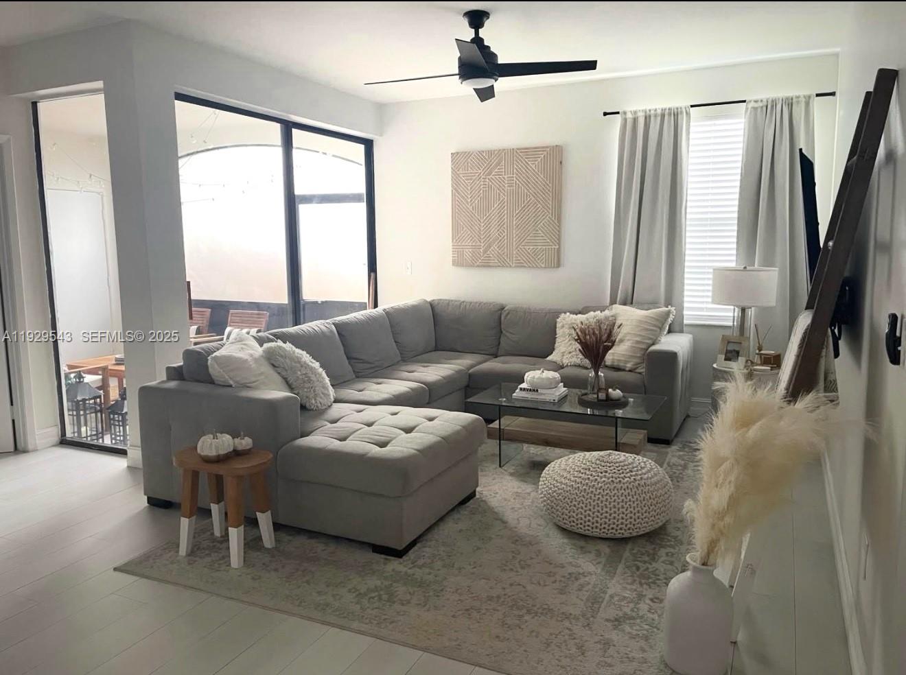 11864 Northwest 11th Street, Unit 11864 Pembroke Pines, FL 33026 - Photo 3 of 13 a living room with furniture and a large window