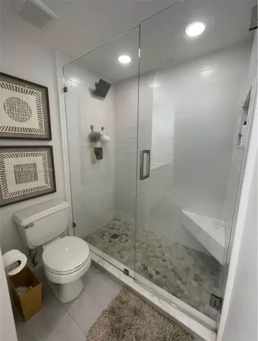 a bathroom with a toilet and a shower
