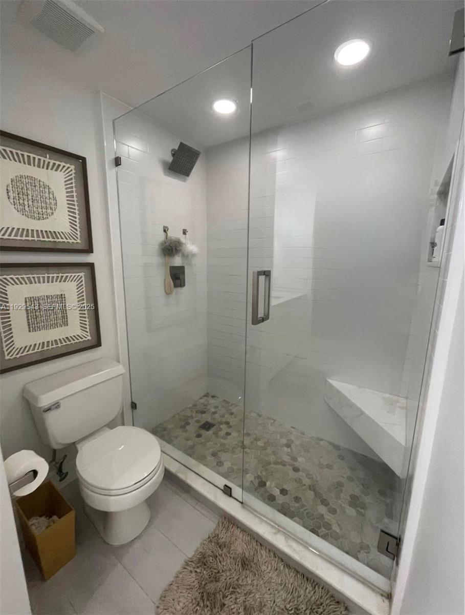 11864 Northwest 11th Street, Unit 11864 Pembroke Pines, FL 33026 - Photo 5 of 13 a bathroom with a toilet and a shower