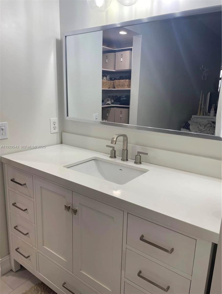 11864 Northwest 11th Street, Unit 11864 Pembroke Pines, FL 33026 - Photo 6 of 13 a bathroom with a sink and a mirror