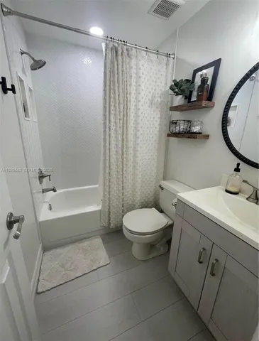 a bathroom with a toilet sink and shower