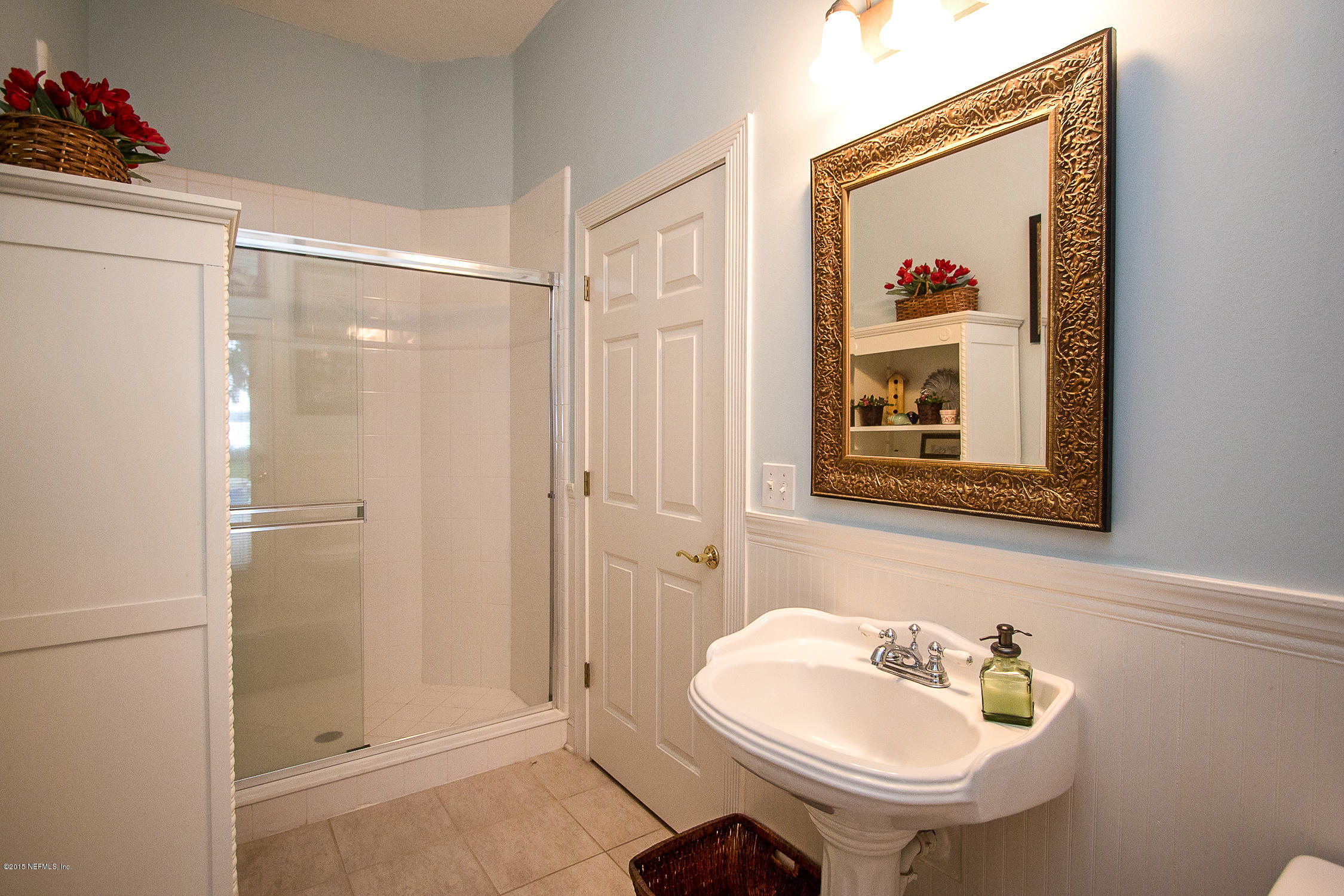 3122 Nautilus Road Middleburg, FL 32068 - Photo 42 of 64 a bathroom with a sink and a mirror
