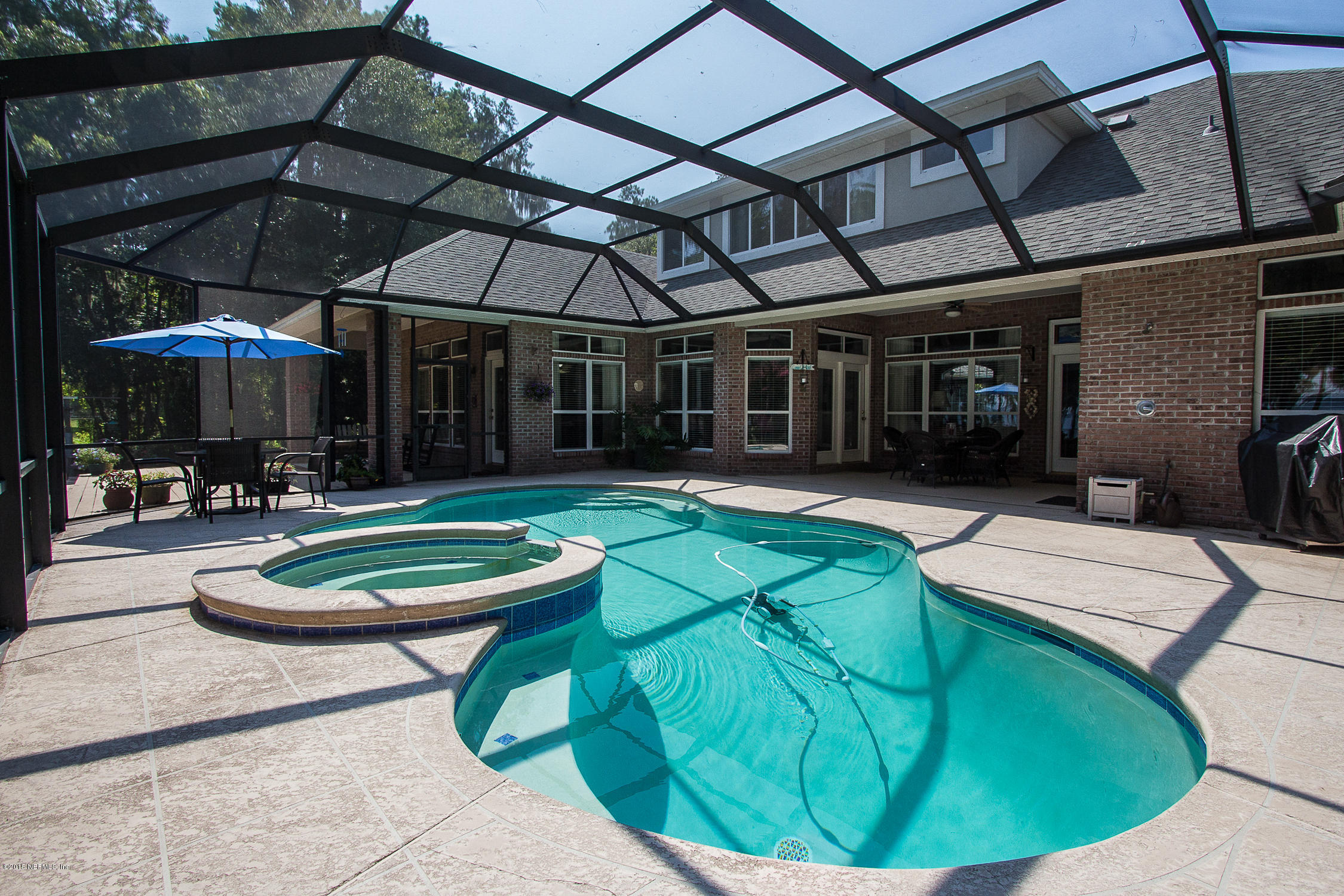 3122 Nautilus Road Middleburg, FL 32068 - Photo 54 of 64 a view of a backyard with table and chairs under an umbrella