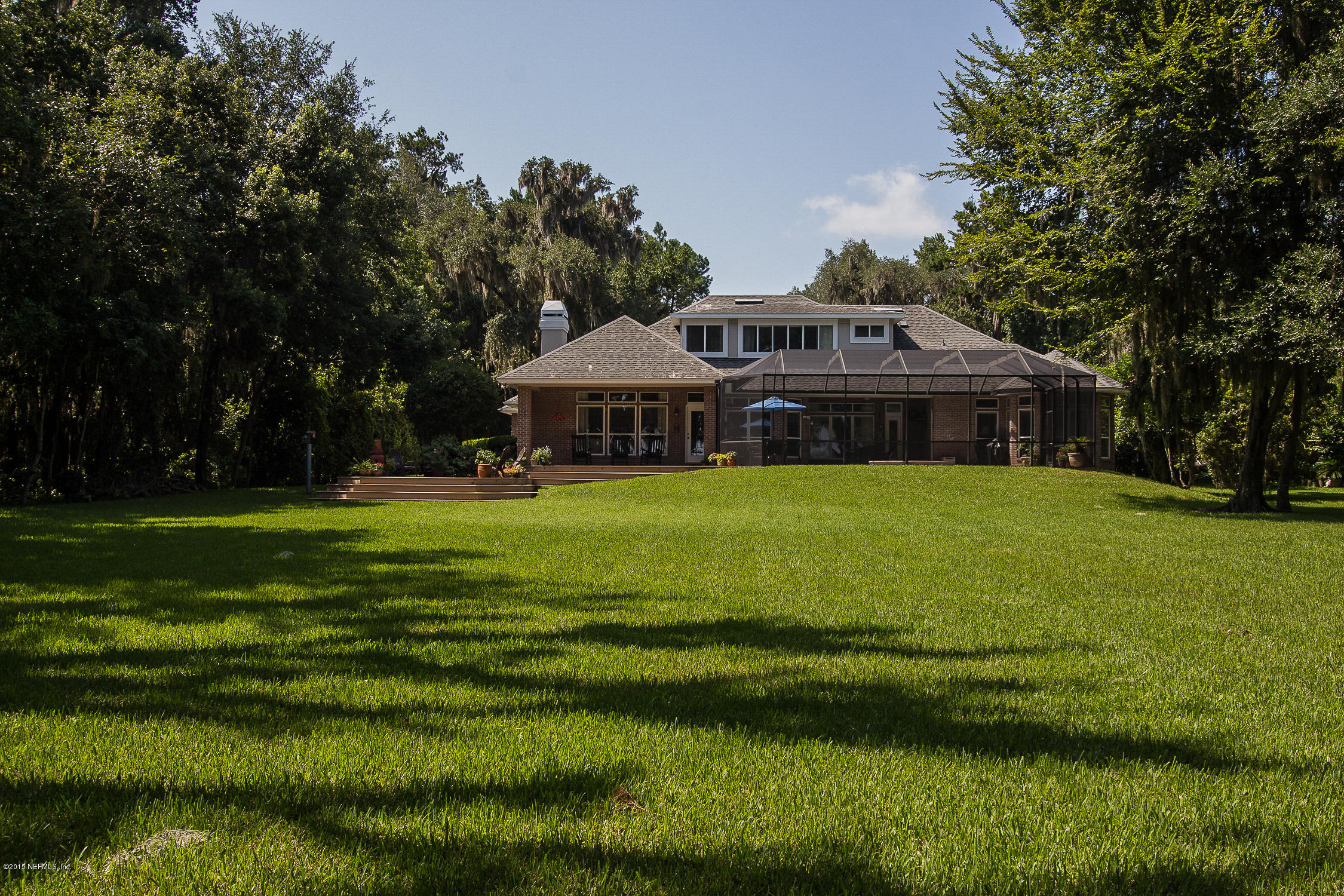 3122 Nautilus Road Middleburg, FL 32068 - Photo 60 of 64 a white house with a big yard and large trees