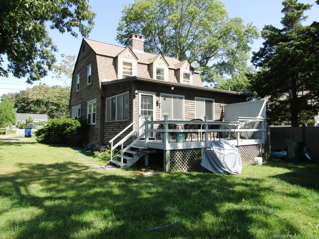 a view of a house with a yard patio and a slide