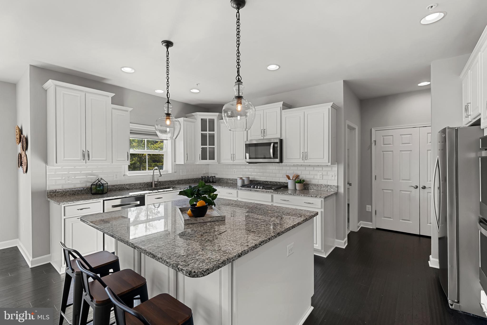 815 Holden Road Frederick, MD 21701 - Photo 17 of 59 a kitchen with stainless steel appliances granite countertop a sink a stove a refrigerator and island