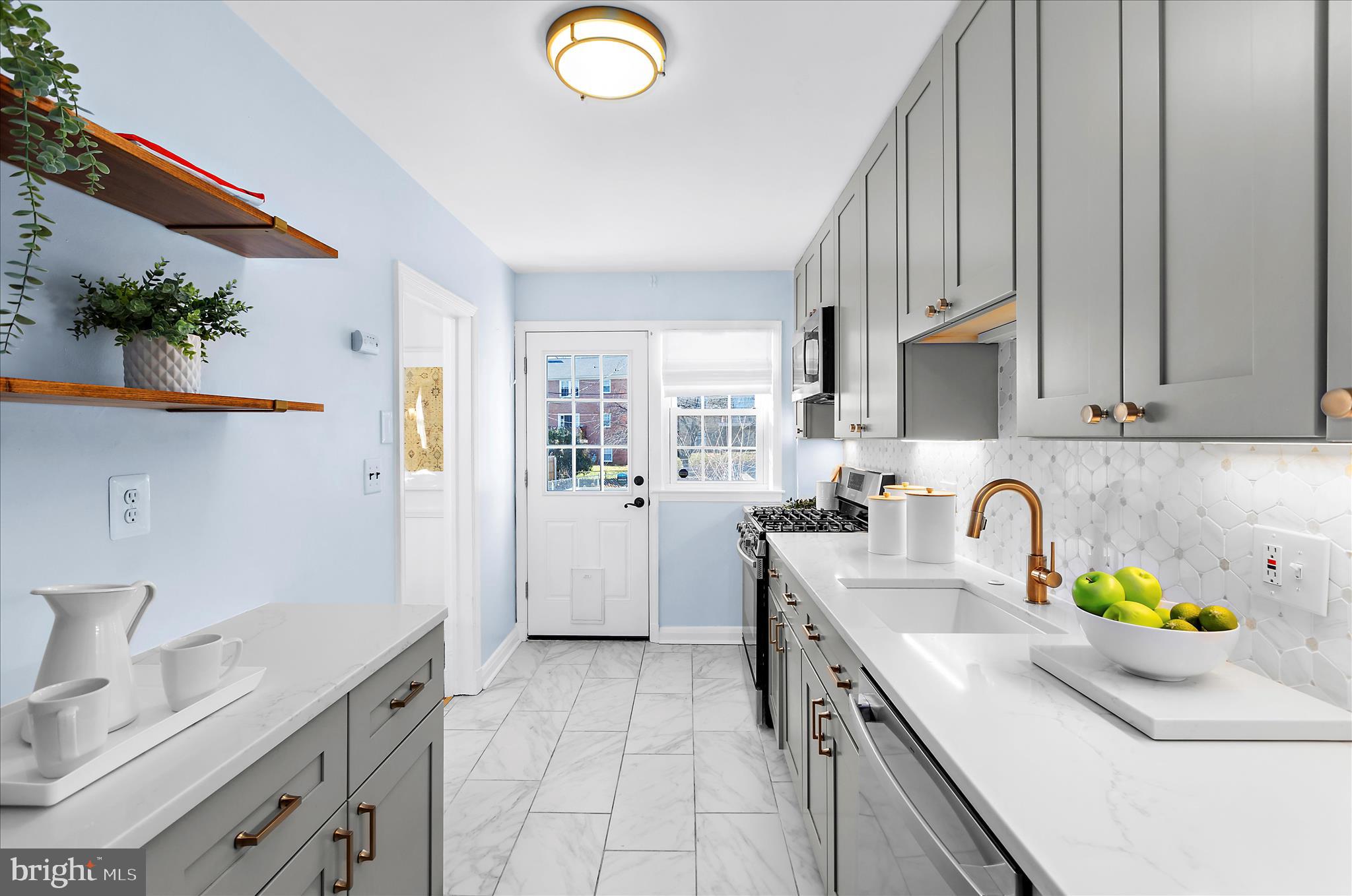 312 Small Court Catonsville, MD 21228 - Photo 15 of 41 a kitchen with a sink a stove cabinets and a window