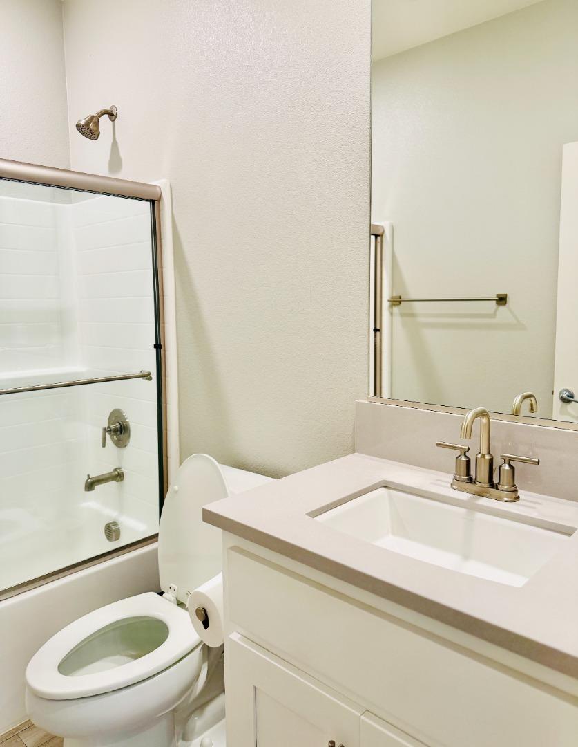 1946 Pollock Way Lodi, CA 95242 - Photo 18 of 35 a bathroom with a sink a toilet and a mirror