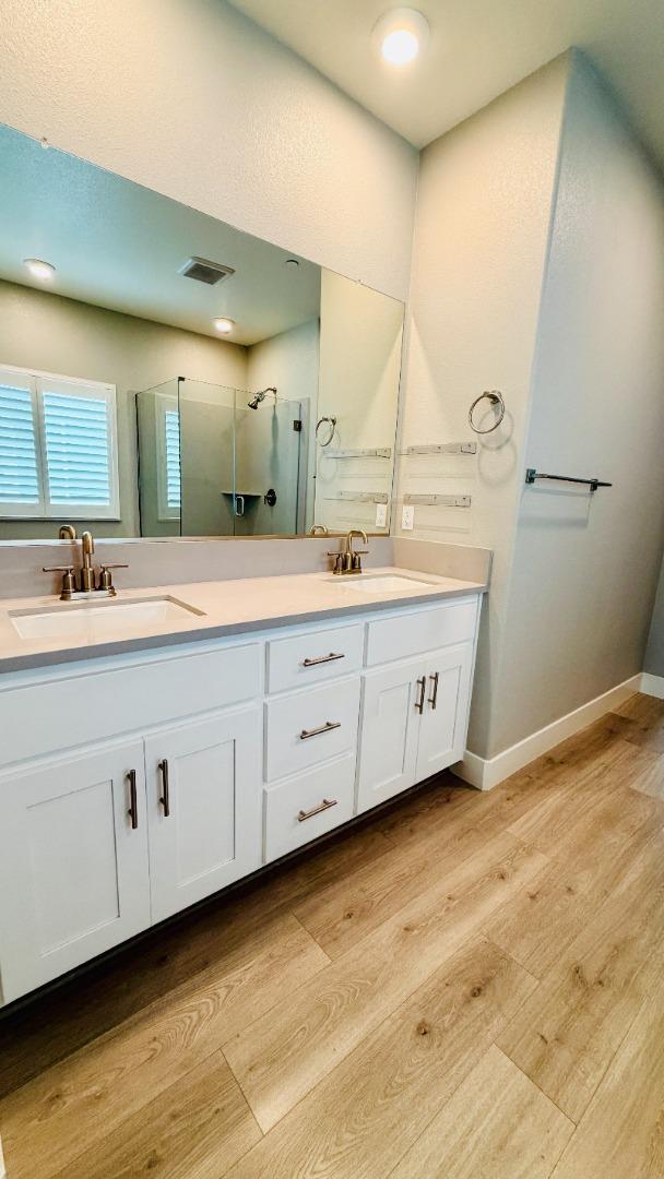 1946 Pollock Way Lodi, CA 95242 - Photo 28 of 35 a bathroom with a double vanity sink and mirror